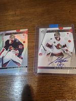 Front view of both autographed Mads Sogaard cards in holders
