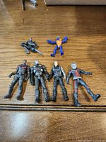 Front view of all seven figures laid on table