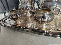 close-up of creamer and sugar bowl on tray