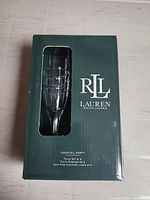 Front of original Ralph Lauren box with viewing window showing one flute and branding