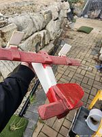 Left underside view of wooden red and white model airplane