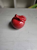 Front view of red porcelain apple figurine showing glossy finish