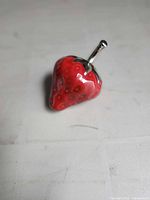 Front view of ceramic strawberry with silver stem