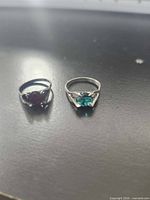 Both rings side by side showing stones and settings