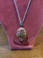 Front view of necklace on display form showing pendant details