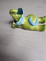 Elephant figurine side view showing green body and blue blanket accent