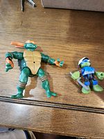 Front view of both TMNT action figures on table