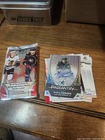 Opened pack, autograph card and stack of remaining cards on desk