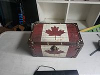 Closed wooden box showing Canadian flag design and latch
