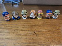 Front view of all seven figurines lined up