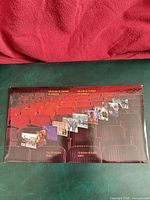 Front of presentation folder showing theatre seats and stamp thumbnails