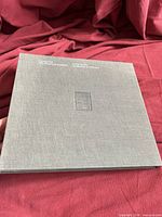 Front cover of grey cloth hardcover folio