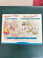 Front cover of souvenir sheet folder showing Winnie the Pooh graphics