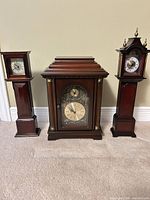 Front view of all three Bombay Company clocks