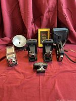 Group shot showing all cameras, flash, case, box sleeve