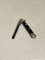 Comb partially open displaying teeth and handle