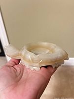 Oblique view of turtle-shaped onyx ashtray showing overall shape and coloration