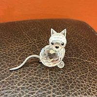 front view of clear faceted crystal cat with silver-tone tail