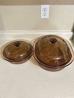 Both casserole dishes with lids side by side