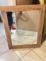 Front view of rectangular wood-framed mirror