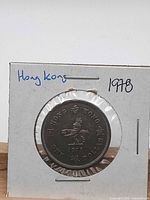 Reverse side showing Hong Kong design, denomination and date within cardboard holder
