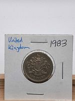 Reverse of 1983 £1 coin showing royal arms in flip