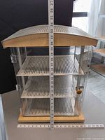 Front view showing entire display case with ruler for scale