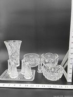 group shot showing all eight crystal pieces with rulers for scale