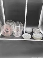Overview of all clear and pink glass plates with measuring tape for scale