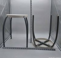 One stool upright, one inverted showing full structure and rulers for scale