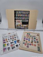Overview of three album sheets with Indonesian stamps mounted and loose