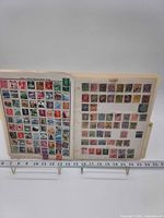 Overview of first album sheet showing numerous Japanese stamps