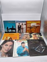 Front view of eight LPs including Arlo Guthrie, Carpenters, Hank Williams, Al Hirt, Wham!, Kenny Rogers, Supertramp and one further sleeve