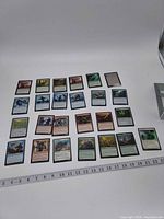 All 25 cards laid out in rows with ruler for scale