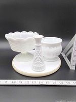 Front view of all three white milk glass vases on measuring board