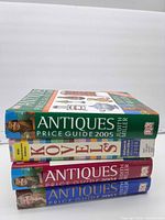 Spine view of all four books stacked: DK Antiques Price Guide 2005, Kovels 2008, DK Antiques Price Guide 2004