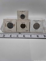 Front view of all four coins in flips with identifying labels