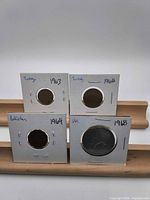 Composite view of four coins in flips labeled Turkey 1963, Turkey 1962, Pakistan 1964, UK 1968