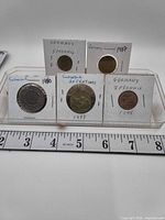Front view of all five coins in flips, labels visible