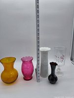 Group shot of all five vases with ruler showing scale