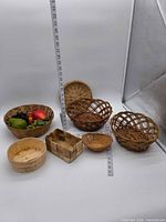 All seven baskets and faux fruit grouped