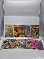 Front covers of seven upright comics and two horizontal, showing overall lot