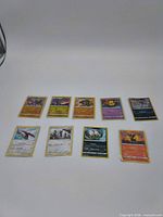 Wide shot of all 9 Pokémon cards in two rows