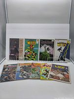 Nine comic books displayed in two rows