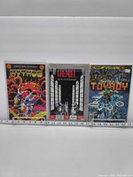 Front covers of Mythos, Grendel, Turbo