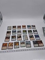 Full 5×5 grid of 25 Magic: The Gathering cards with ruler for scale
