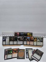 Group shot of about 25 Magic cards displayed on stands