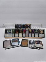 All 26 Magic cards front side and some backs displayed on stands