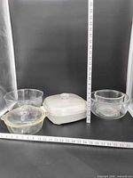 All dishes lined up with ruler for scale