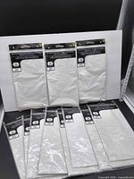 Front view of all eleven packaged white tablecloths